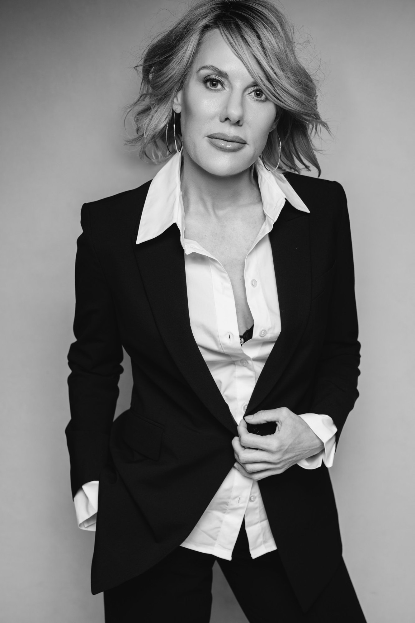 Carissa A. Jakobe, standing, in a black-and-white studio portrait